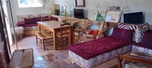 a living room with a couch and a fireplace at Relai de randonnées pédestres, cévenoles, bassin en eau de source, randonnées d'ânes abreuvoir et enclos in Monoblet