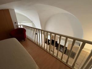 un escalier en colimaçon avec une chaise rouge et un escalier. dans l'établissement Appartamento Corso Diaz, à Sannicandro di Bari