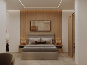 a bedroom with a large bed and two lamps at BAZ Hotel University District in Baghdād +63 photos