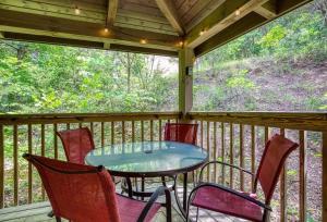 a table and chairs on a screened in porch at Stairway To Heaven By Beyond Expectations in Sevierville