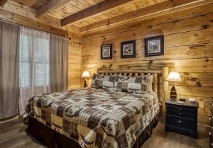 a bedroom with a bed and wooden walls at Stairway To Heaven By Beyond Expectations in Sevierville +38 photos