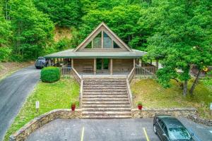 a house with a car parked in front of it at Stairway To Heaven By Beyond Expectations in Sevierville
