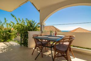 a patio with a table and chairs on a balcony at Apartments Petar Maksan in Pakoštane