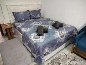 a bedroom with a bed with a blue blanket and pillows at ilkay's House in Makri