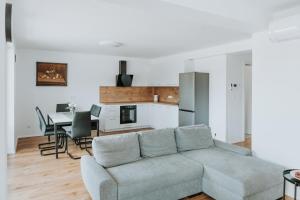 a living room with a couch and a table at Apartments Naklo in Naklo