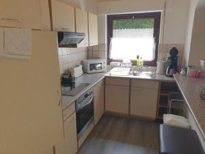 a small kitchen with a sink and a window at FeWo Eifel-Oase mit Garten in Mechernich