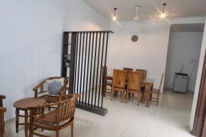 a dining room with a table and chairs at Homestay Terraloka in Malacca