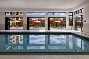 an indoor pool in a building with windows at Naturally Pacific Resort in Campbell River