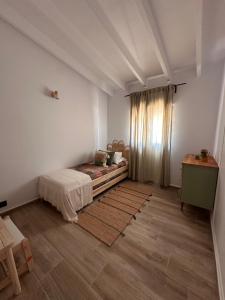 a bedroom with a bed and a table and a window at Villa Jade Moraira in Moraira