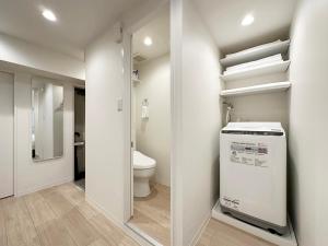 a small bathroom with a toilet and a sink at F Style Namiki in Hiroshima