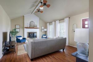 a living room with a couch and a fireplace at Serene Getaway with Patio in Pineville in Charlotte