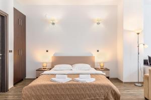 a bedroom with a large bed with two towels on it at Alpine Escape Studio - Silver Mountain Resort & SPA - Poiana Brasov in Poiana Brasov