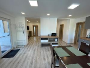 a living room with a table and a desk at Dom Karolína in Tureň