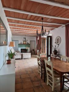 a dining room with a wooden table and chairs at Corteganillas in Cortegana