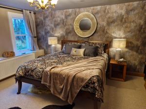 a bedroom with a bed and a mirror on the wall at Drumee Lodge boutique B and B, Newcastle, County Down in Newcastle +170 photos