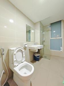 a white bathroom with a toilet and a sink at Sutera Avenue Rooftop Infinity Pool KK Infini Stay in Kota Kinabalu