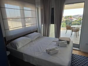 a bedroom with a bed with two towels on it at Apartman Plesa in Povljana