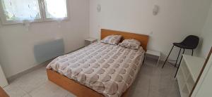 a bedroom with a bed and a chair in it at La zen escapade in Ollioules