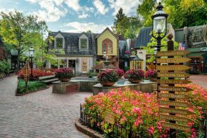 a street with flowers in front of a house at Groot's Place - 5 min to main parkway!! in Pigeon Forge