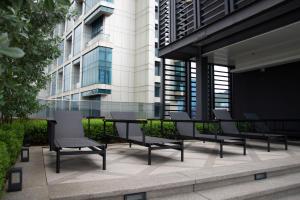 a table and chairs in front of a building at 5 Mossaz Muji 2 room at Empire City by Light House in Petaling Jaya