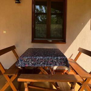 a picnic table with a floral table cloth on it at Viola Apartman in Zamárdi +9 photos