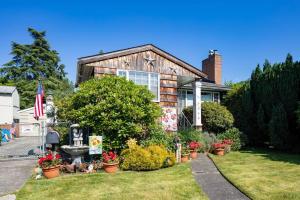 a house with a flower garden in front of it at Seaview Hideaway Heated Floors, free parking in Seattle