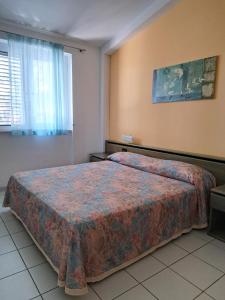 Una cama o camas en una habitación de Villaggio Internazionale Punta del Diamante
