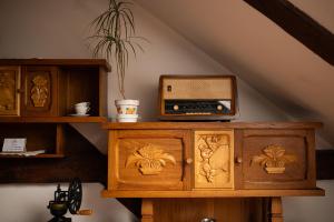 a wooden cabinet with a radio on top of it at Folwark Pszczew in Pszczew