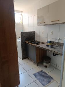 a kitchen with a sink and a stove top oven at AP 102 Acolhedor situado na Zona Leste, com 3 quartos sendo 1 suíte in Teresina