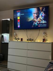 a flat screen tv sitting on top of a dresser at Cozy Rhodes Studio in Rhodes Town