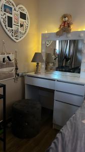a bedroom with a desk with a mirror and a lamp at Cozy Rhodes Studio in Rhodes Town +4 photos