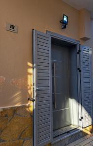 a sliding glass door on the side of a building at Andrea House in Berat