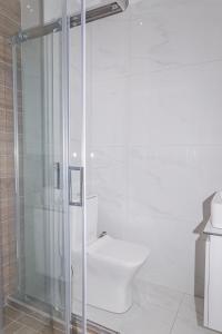 a bathroom with a toilet and a glass shower at Cozy Studio in the City Center in Thessaloniki