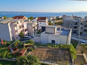 an aerial view of a city with buildings and the ocean at Sunshine Apartments Podstrana in Podstrana