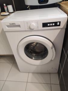 a white washing machine sitting in a bathroom at Bienvenue chez Coco in Dunkerque