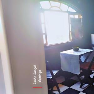a room with a table and a window at Mansão Espetacular , vista para lagoa in São Pedro da Aldeia