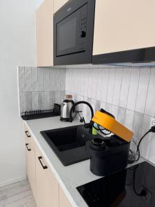 a kitchen with a sink and a microwave at Old Town Residence, Historic Centre Castle Square in Warsaw