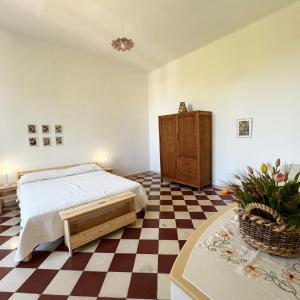 a bedroom with a bed and a checkered floor at Il Sentiero in Bari