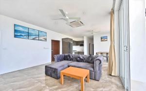 a living room with a couch and a table at Seaview Oasis - 4BR near Beach - Koh Samui in Ban Khlong Mae Nam