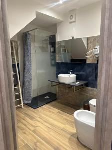 a bathroom with a sink and a toilet and a mirror at Dimora del Centro in Rivarolo Canavese +46 photos
