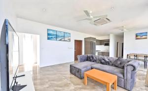 a living room with a couch and a table at Seaview Oasis - 4BR near Beach - Koh Samui in Ban Khlong Mae Nam