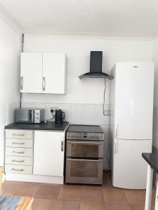 a kitchen with white appliances and a white refrigerator at Kirkby House in Moorthorpe +21 photos