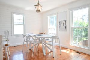 a dining room with a white table and chairs at Walk 0 3 Mile to Bank Street Beach in Harwich +38 photos