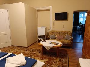 a living room with a couch and a table at Borostyán Vendégház in Nagykőrös