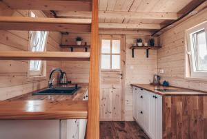 an image of a kitchen in a tiny house at JEZIORAKI Wyjątkowe domki 500m od jeziora Nowa Jedlanka in Uścimów +34 photos