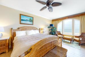a bedroom with a large bed with a ceiling fan at Belmont Towers 801 in Ocean City