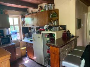 a kitchen with a white refrigerator and a counter at Izletiste Pocivala in Podgorica +24 photos