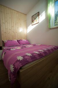 a purple bed with a purple and white bedspread at Slunečná stráň Rudíkov in Rudíkov +17 photos