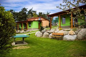 a backyard with a ping pong table and a house at Slunečná stráň Rudíkov in Rudíkov