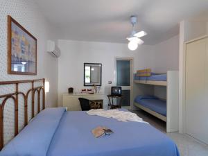 a bedroom with a bed and a desk at Villaggio Le Palme in Ascea